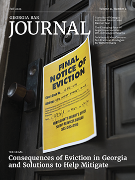 An exterior door painted black with a bright yellow eviction notice attached.