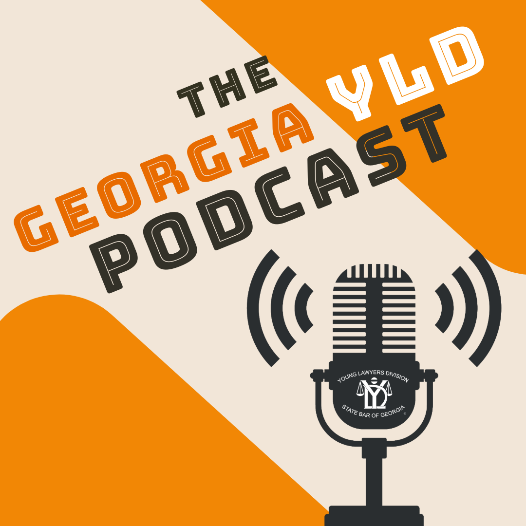 A black microphone on an orange and cream background.